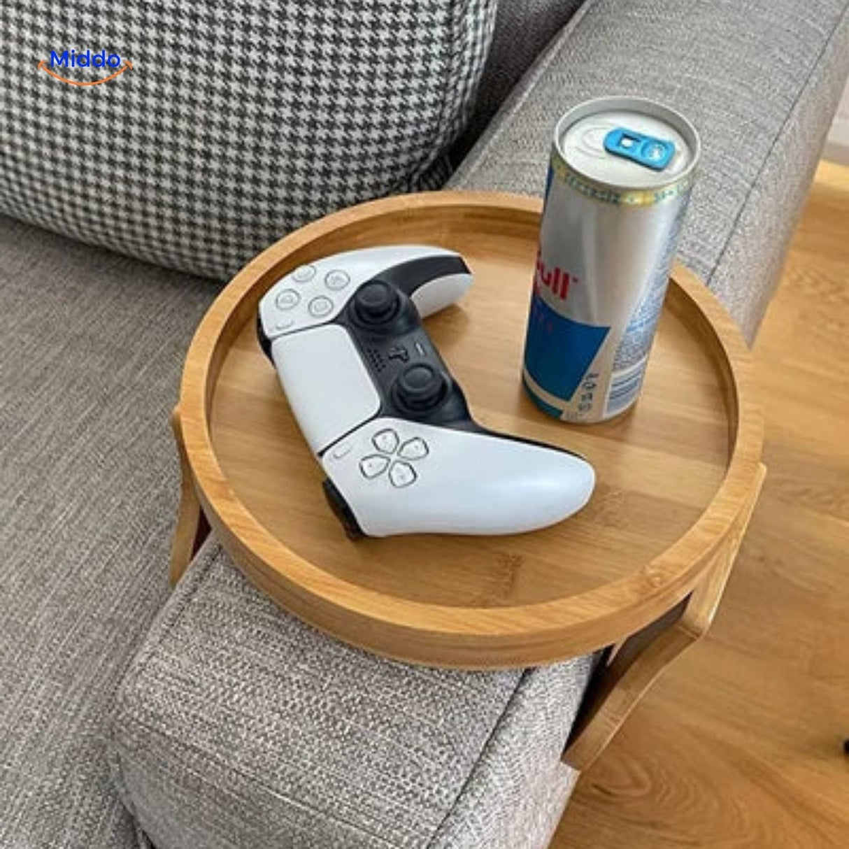 ComfyGrip sofa armrest tray holding controller and drink with bamboo leaf design.
