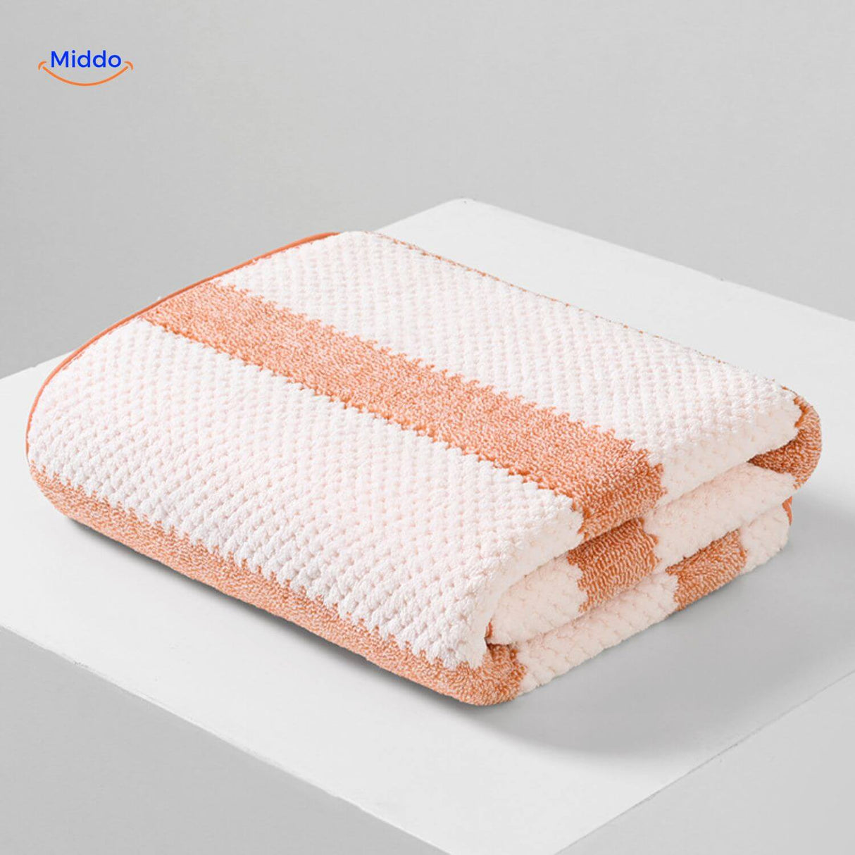 Orange and white striped bath towel with quick-dry technology.