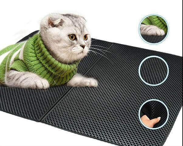 Cat using the waterproof litter mat in a home environment