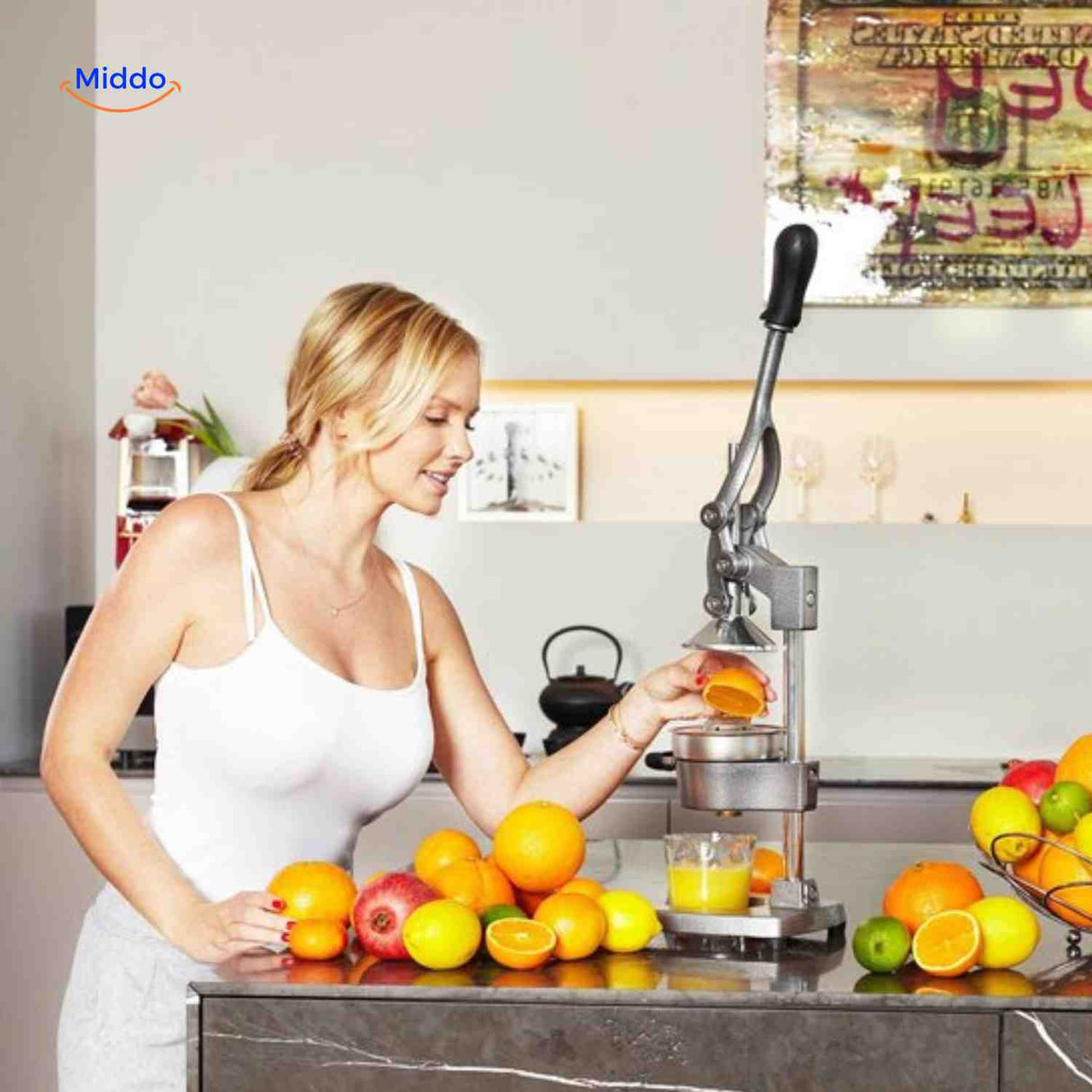 Woman using Citripress cast iron citrus juicer to extract fresh juice in kitchen.