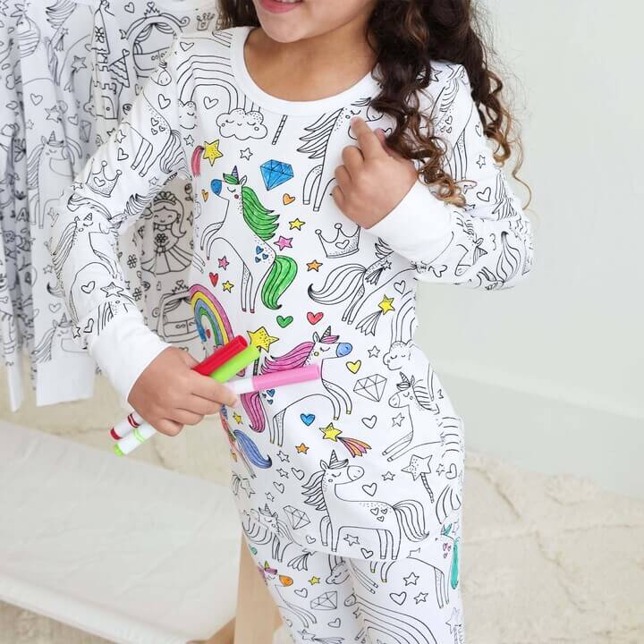 Unicorn-theme color-your-own pajama being colored by child.