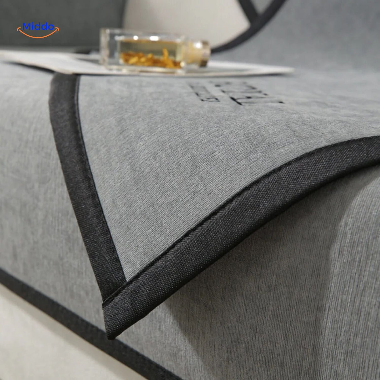 Gray sofa cover styled on corner seating with matching pillows, demonstrating fit and cushion compatibility.