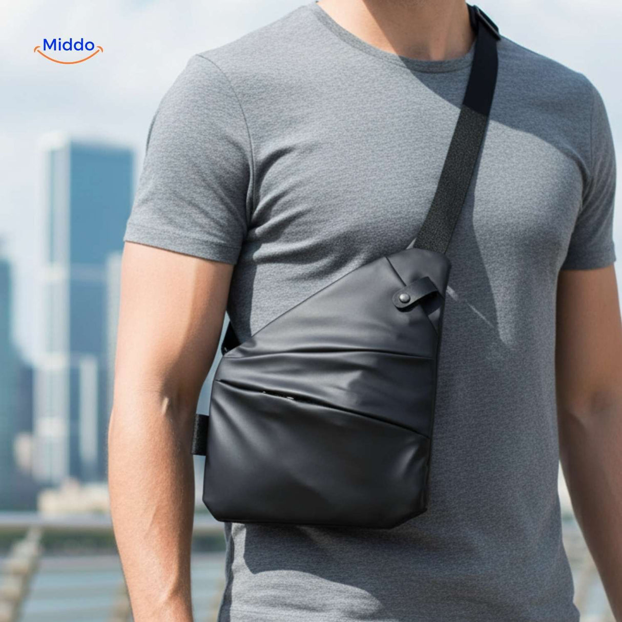 Unisex black Stratos crossbody bag worn over gray shirt during casual travel.