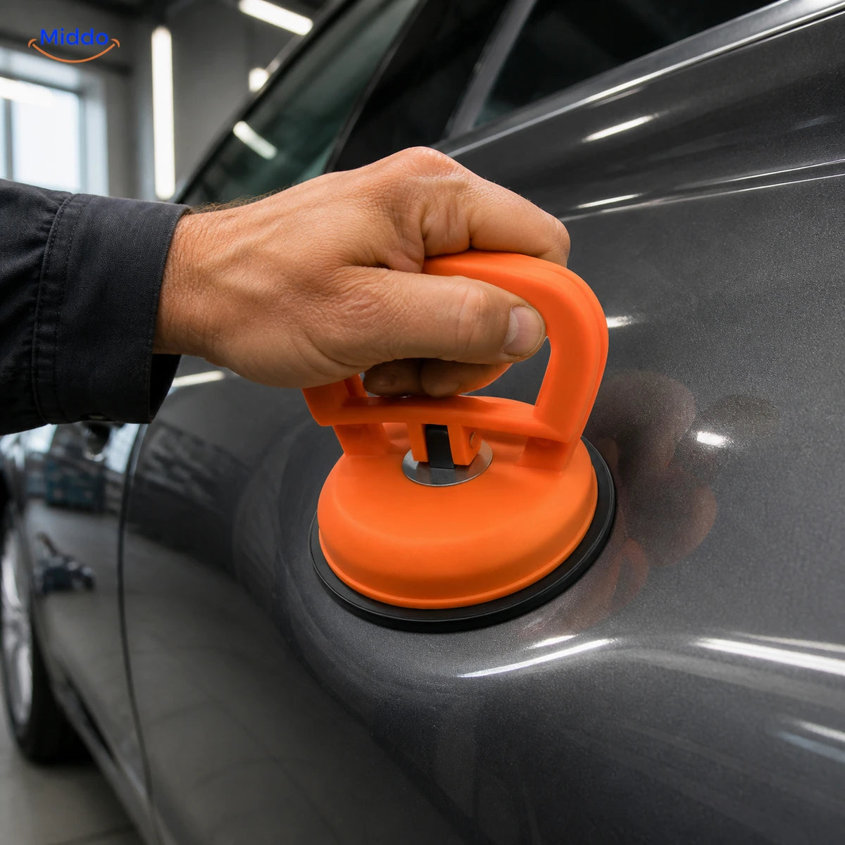 DentGrip orange locking suction cup on a shallow car-panel dent