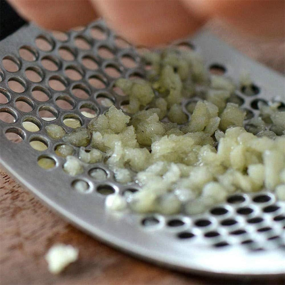 HandyPress garlic press being used to mince fresh garlic cloves efficiently.