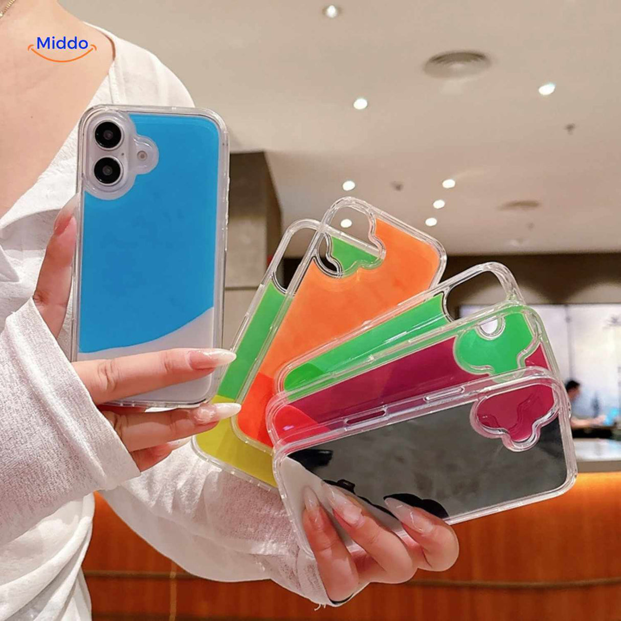 GlowSand phone cases in hand showing bright liquid color mix and glow effect.
