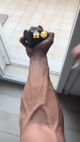 Hand grip strengthening exercise using GripFlex trainer with resistance massage ball.