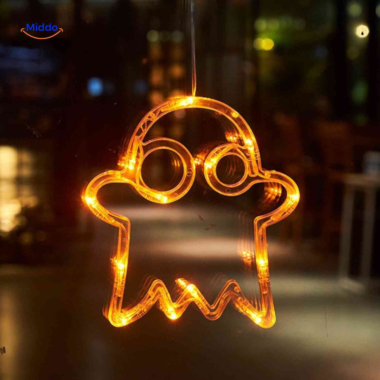 Halloween LED window lamp shaped like a glowing ghost, casting warm orange light on your window.