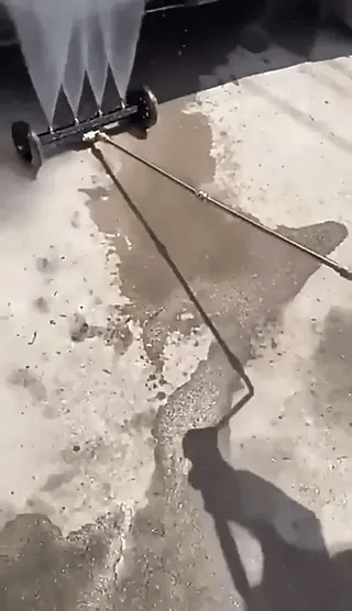 Intensive water jet spray removes dirt and grime from vehicle undercarriage.