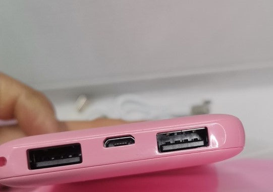 Huggy heated pad showing pink design and power connection details.