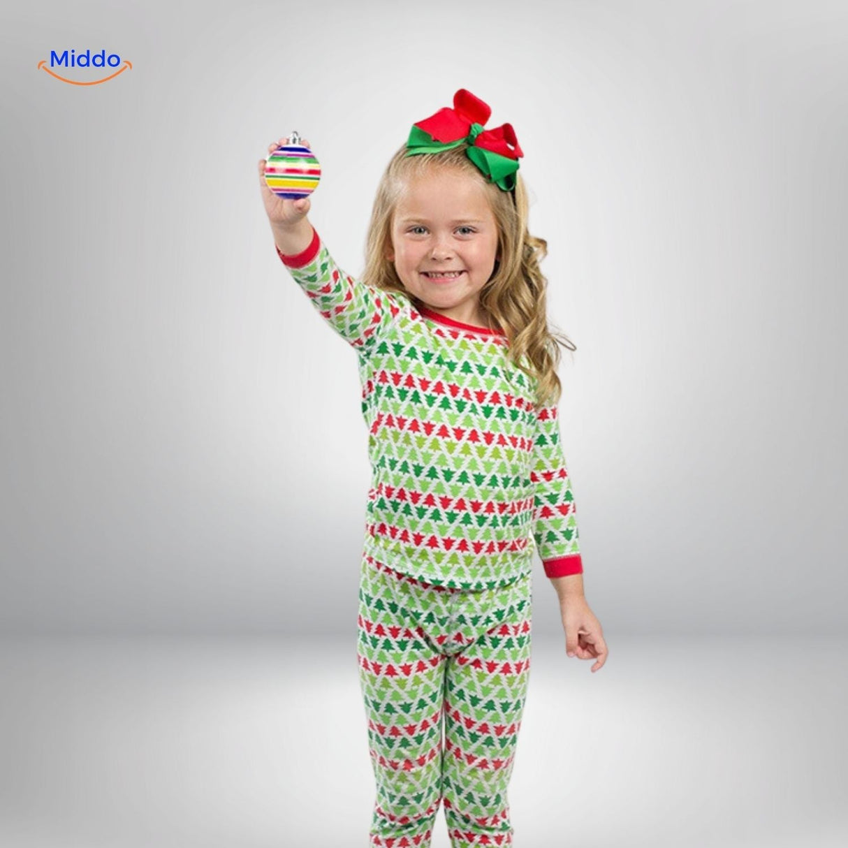 Child holding a completed hand-painted wooden ornament created with TreeMendous kit.