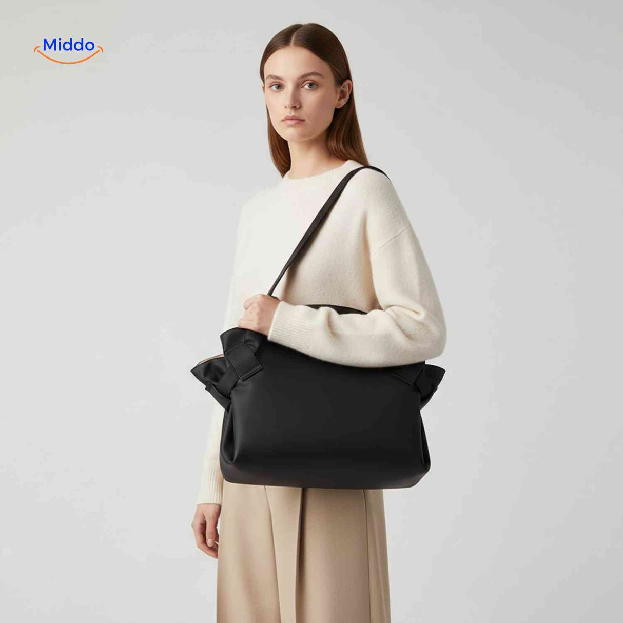 Foldable leather shoulder bag with stylish bow accent detail.