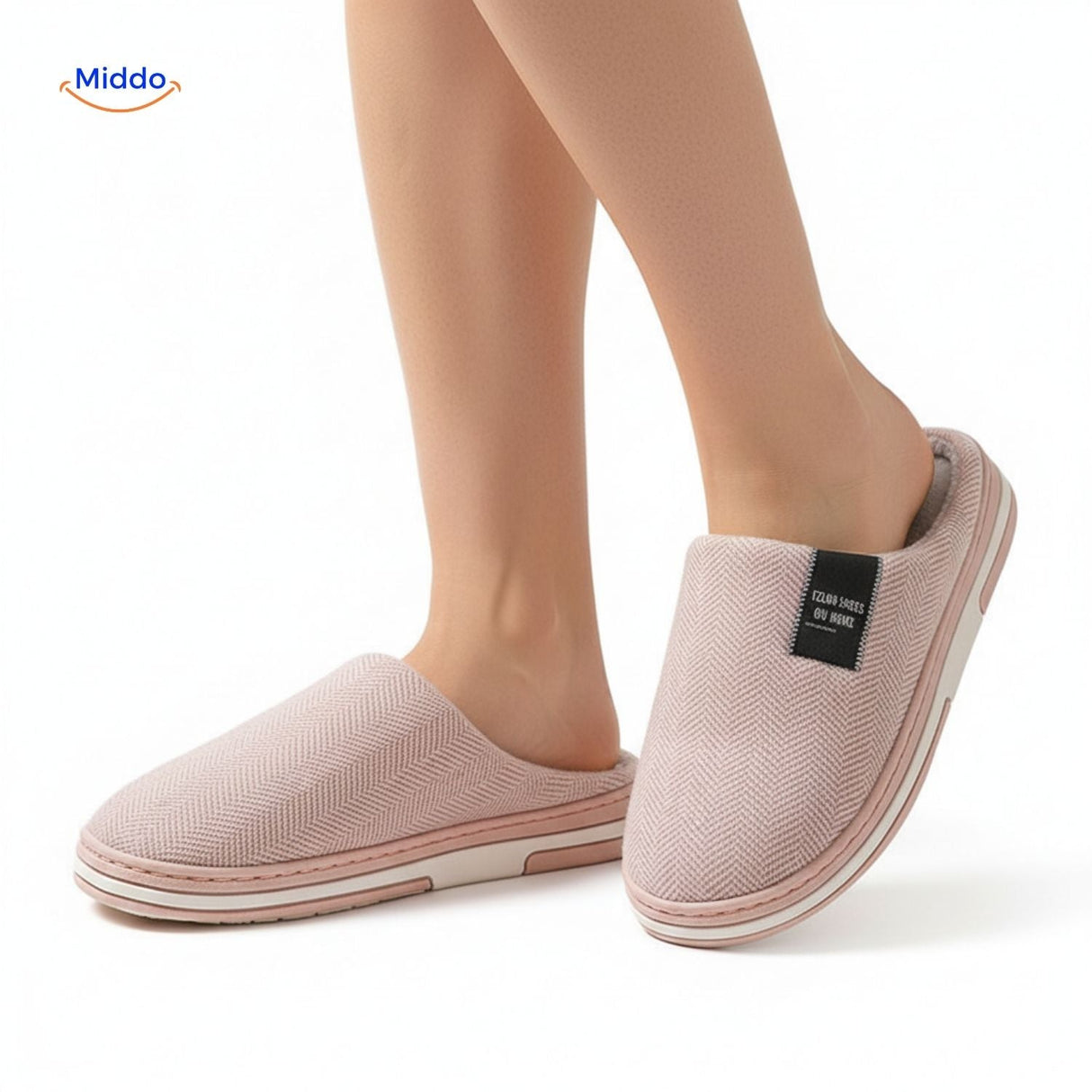 Woman wearing soft light pink non-slip cotton slippers.