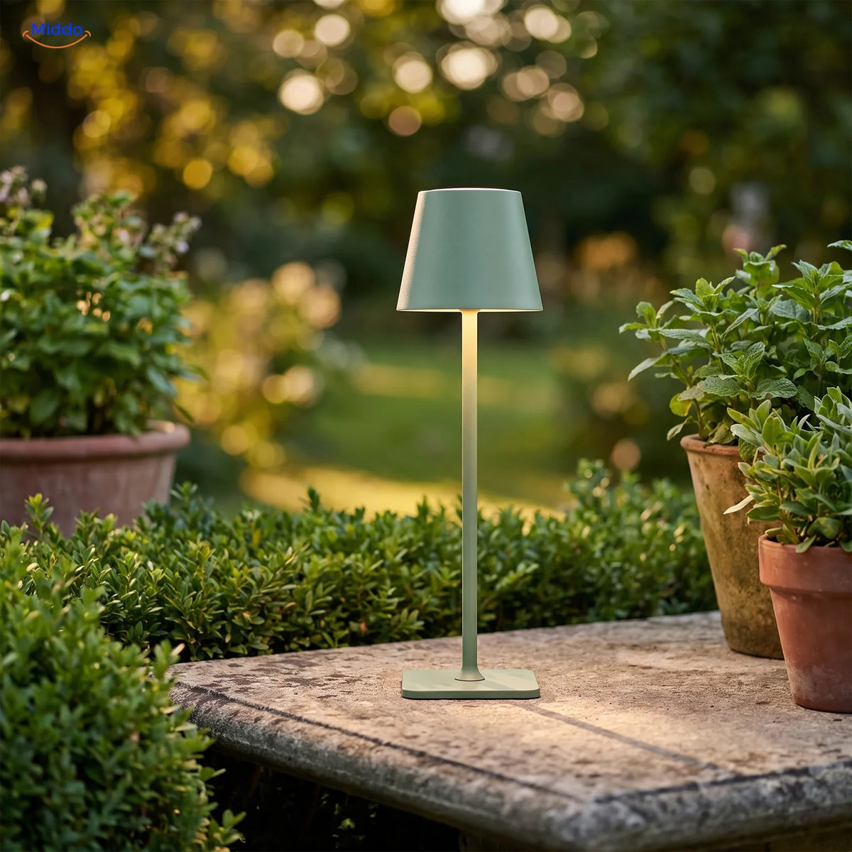 Green Lumiset table lamp on a garden table