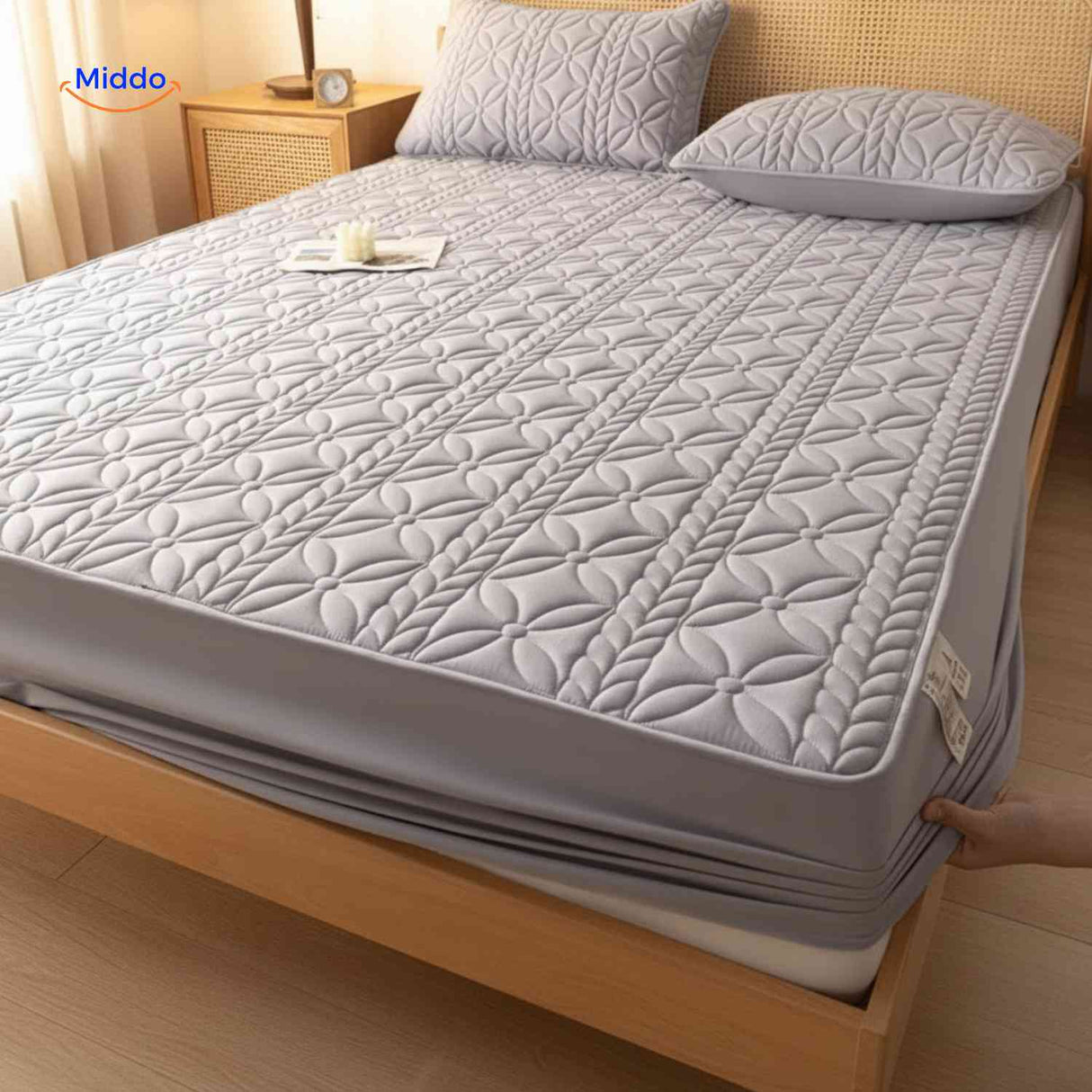 Mattress protector with elastic corners and stretchable sides for secure fit.