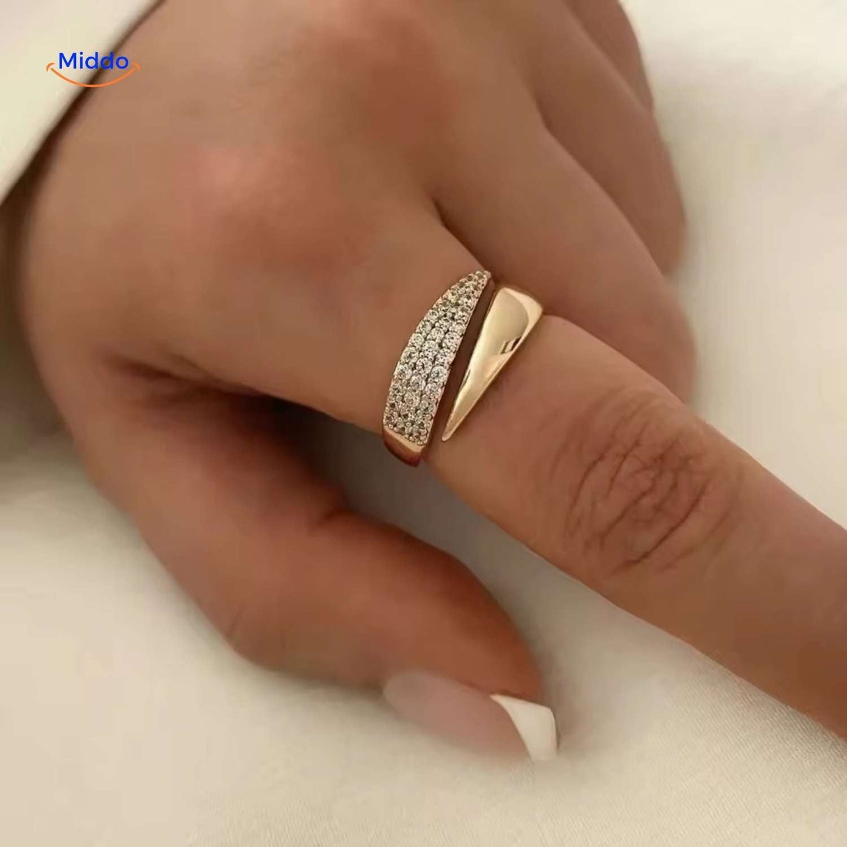 Open-formed adjustable ring with sparkling zirconia close-up on finger.