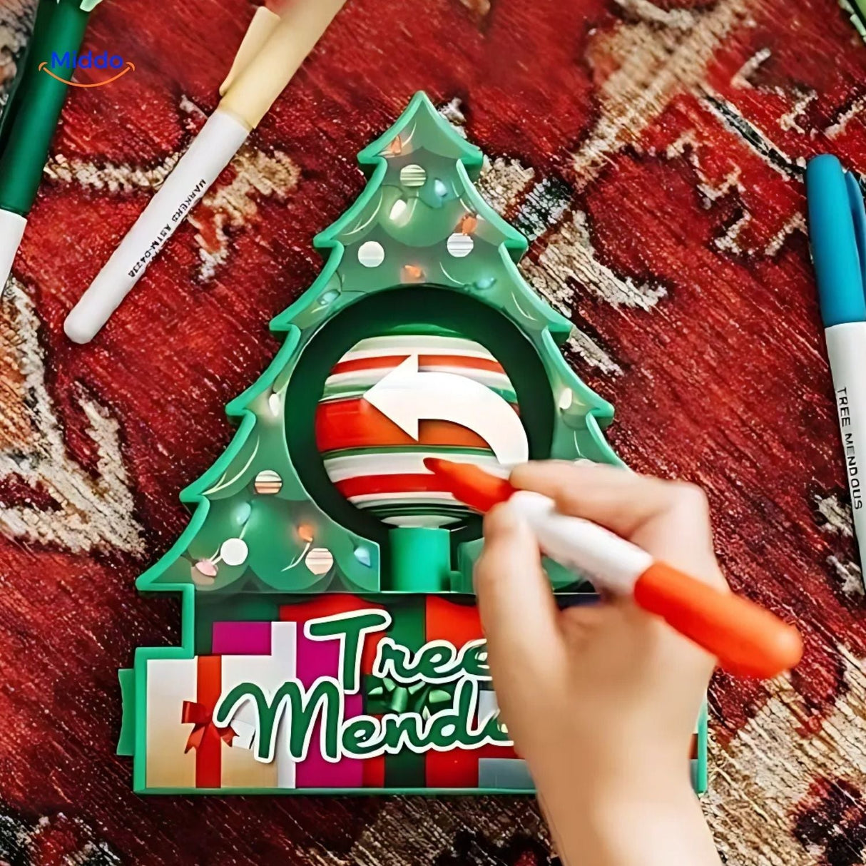 Close-up of electric painting pen decorating a wooden ornament with detailed artwork.