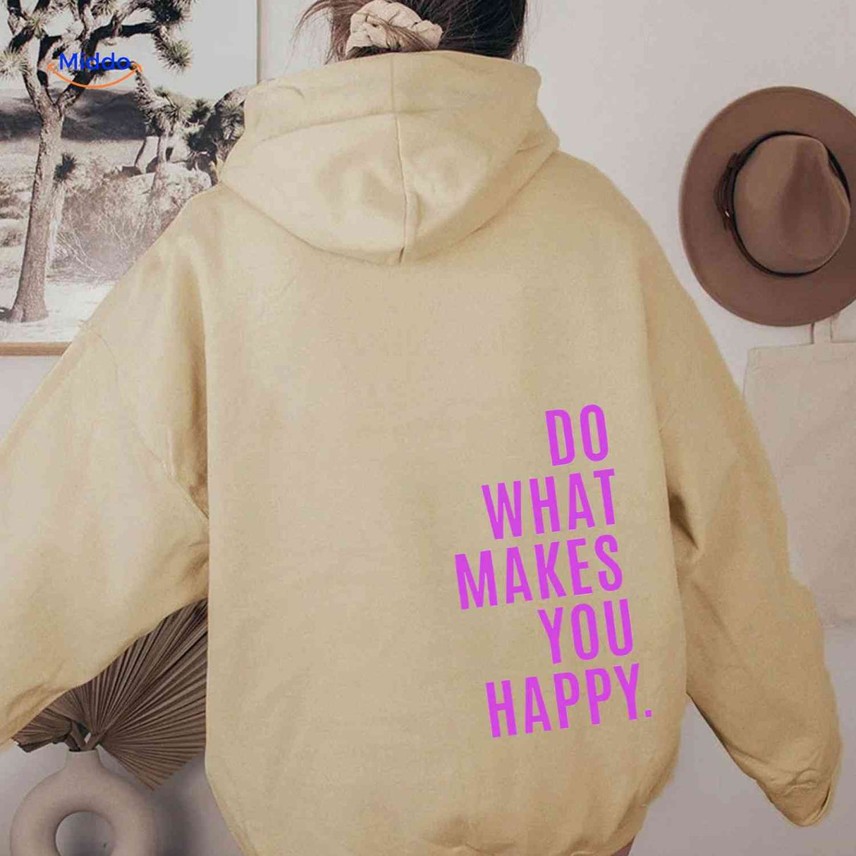 Beige oversized hoodie with pink graphic print.
