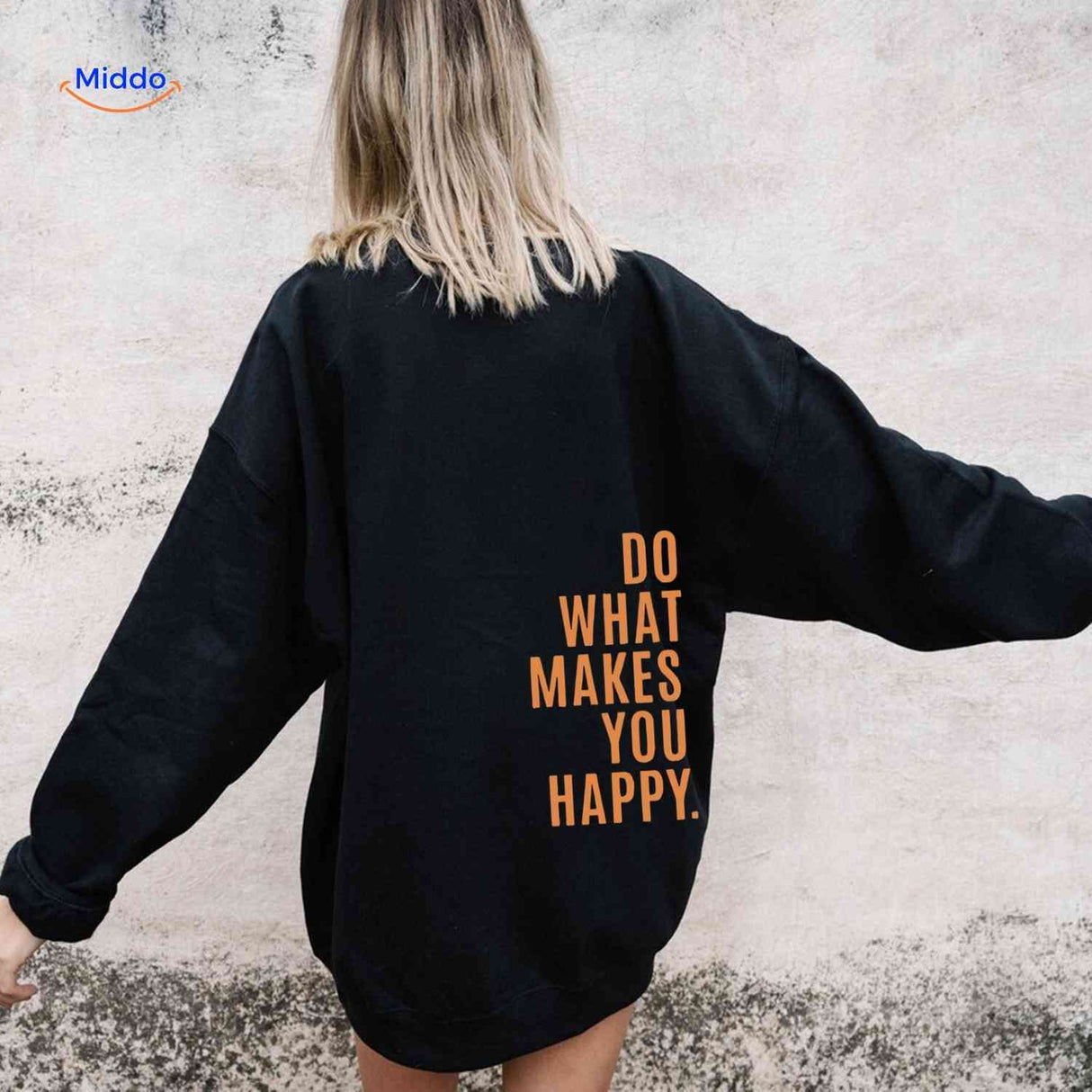 Black oversized hoodie with orange text detail.