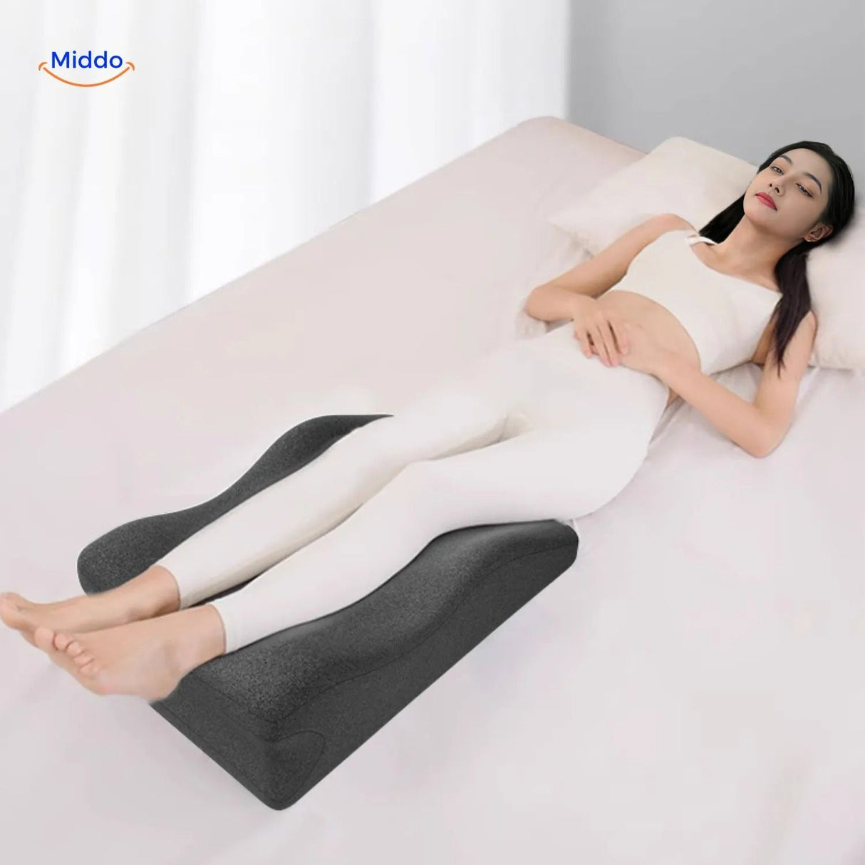 Leg elevation pillow positioned for full body relaxation and pregnancy comfort.