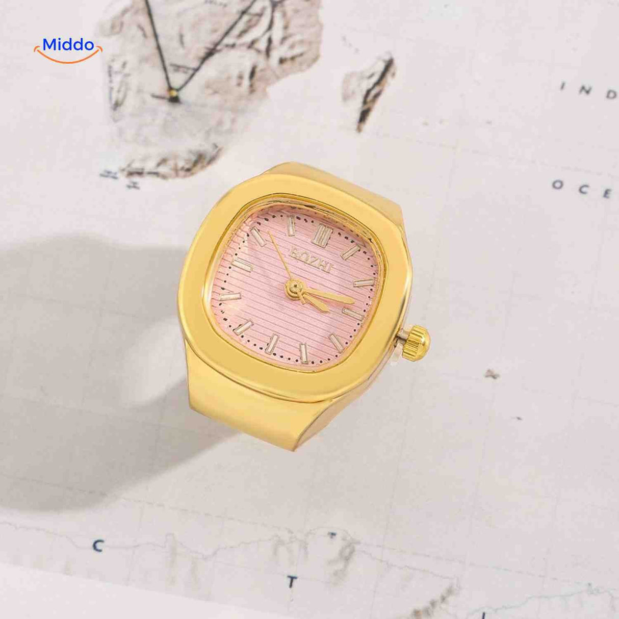 Gold ring watch with pink square dial.