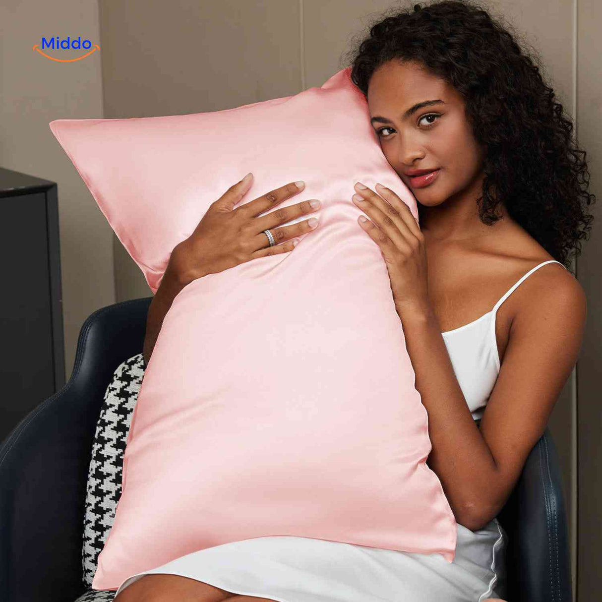 Light pink satin pillowcase on pillow for overnight comfort.