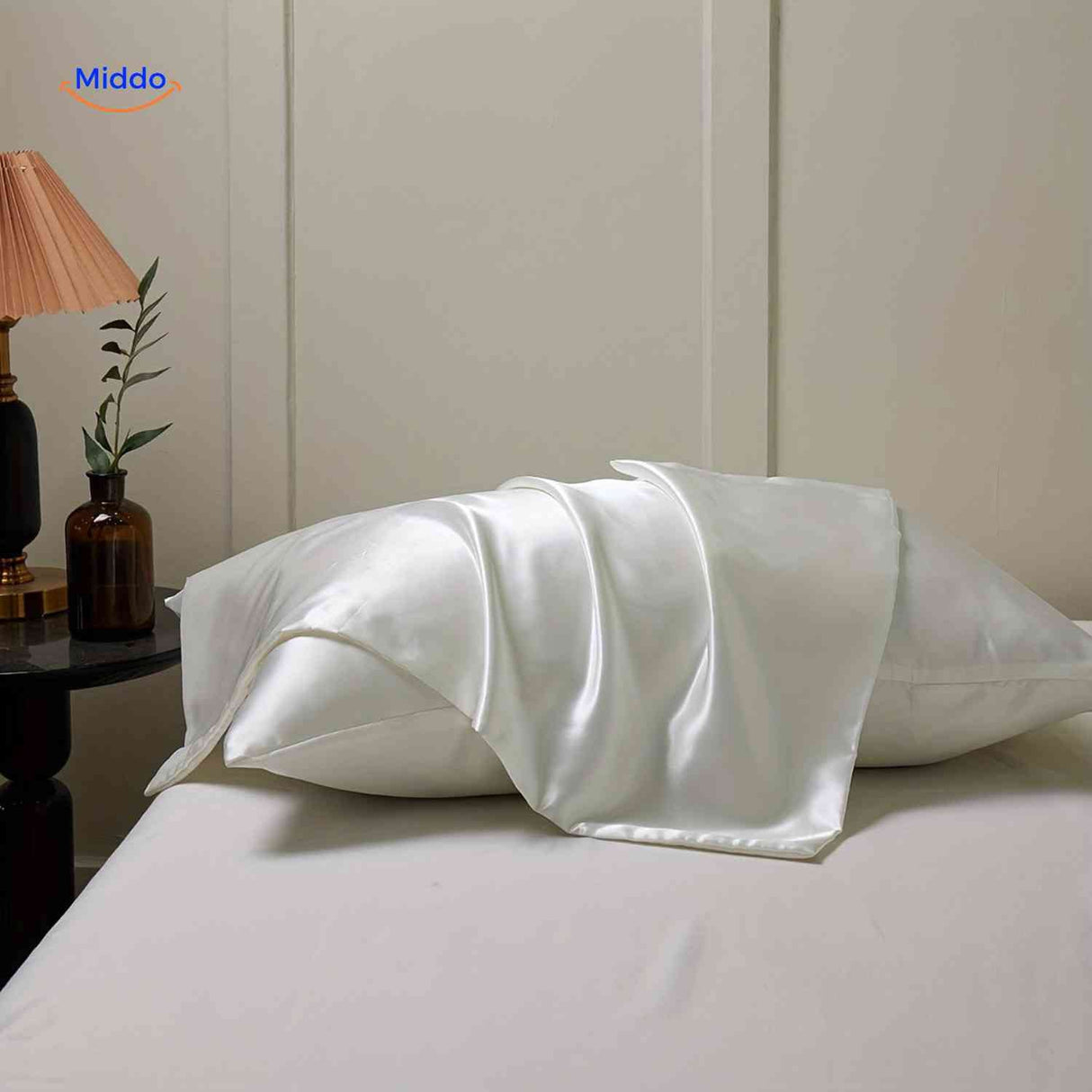 Silver satin pillowcase flat lay featuring luxurious sheen.