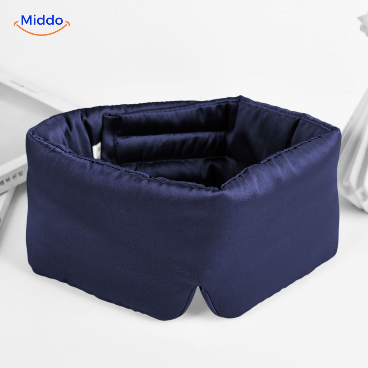 Navy mulberry silk sleep mask featuring breathable reversible construction and elastic strap.
