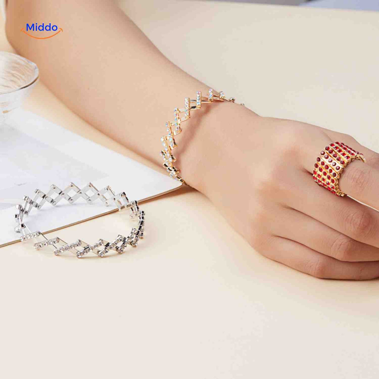 Silver and red ring and bracelet set with crystal rhinestone details.