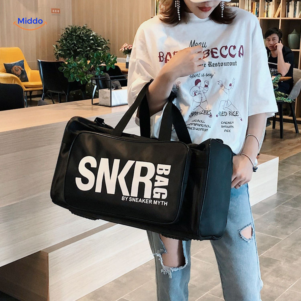 SNKRPro sports bag worn with white shirt showing everyday styling.