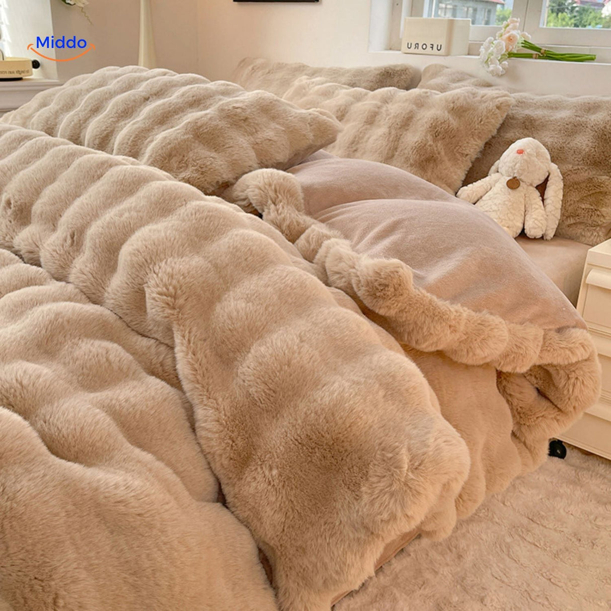 Beige plush rabbit fur duvet with matching pillows.