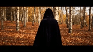 Black velvet Spookora cape in wooded forest setting creating spooky Halloween mood.