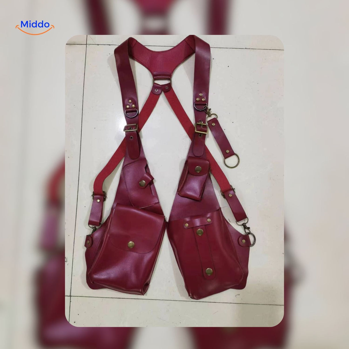 Red leather steampunk shoulder holster bag displayed in studio light.
