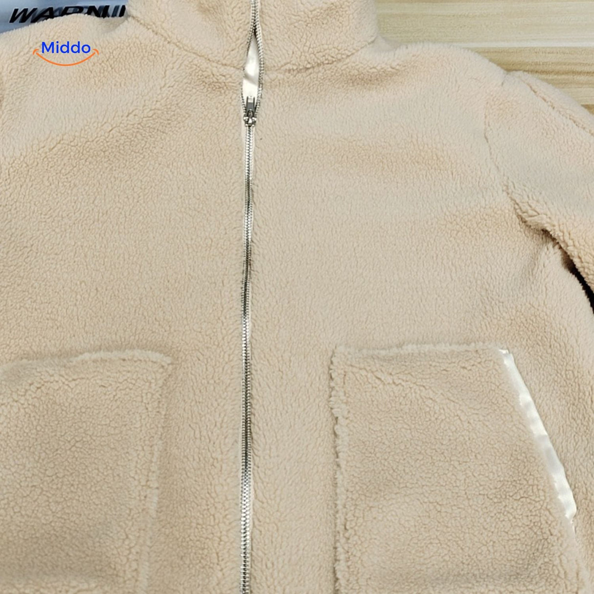 Beige teddy wool coat on white background for clean product presentation.