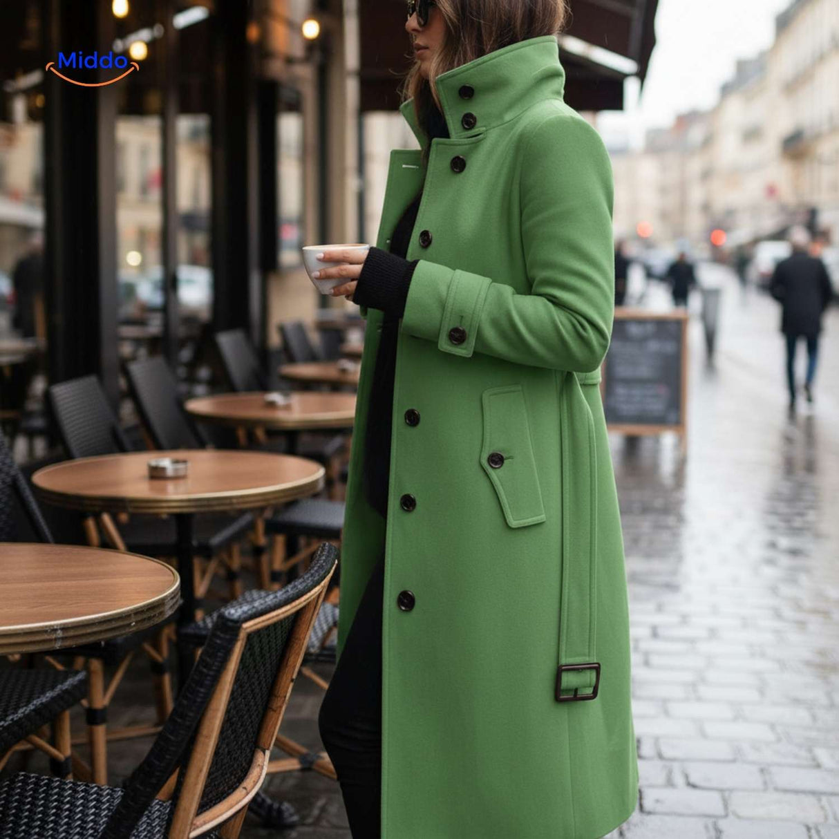 Green Veloura button-front coat styled casually at café location.