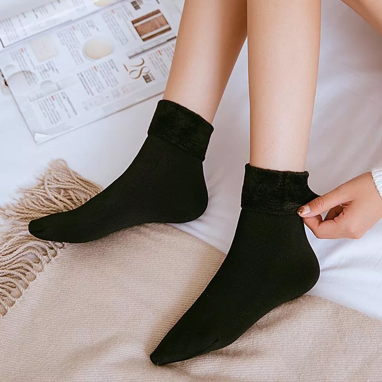 Black winter velvet socks worn for cozy warmth indoors.