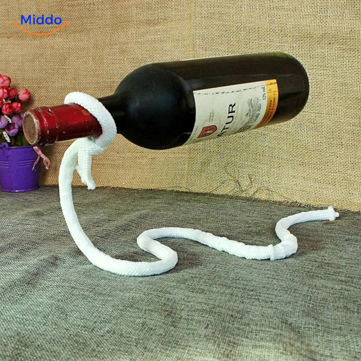 White rope wine bottle holder in home display setting.