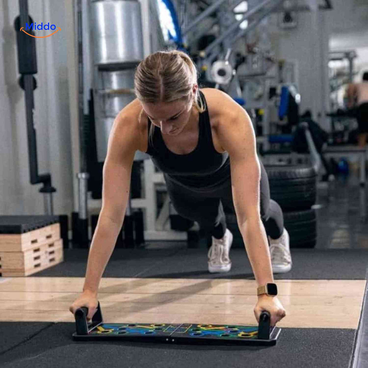 Woman doing push-ups with the board handles for upper body strength.