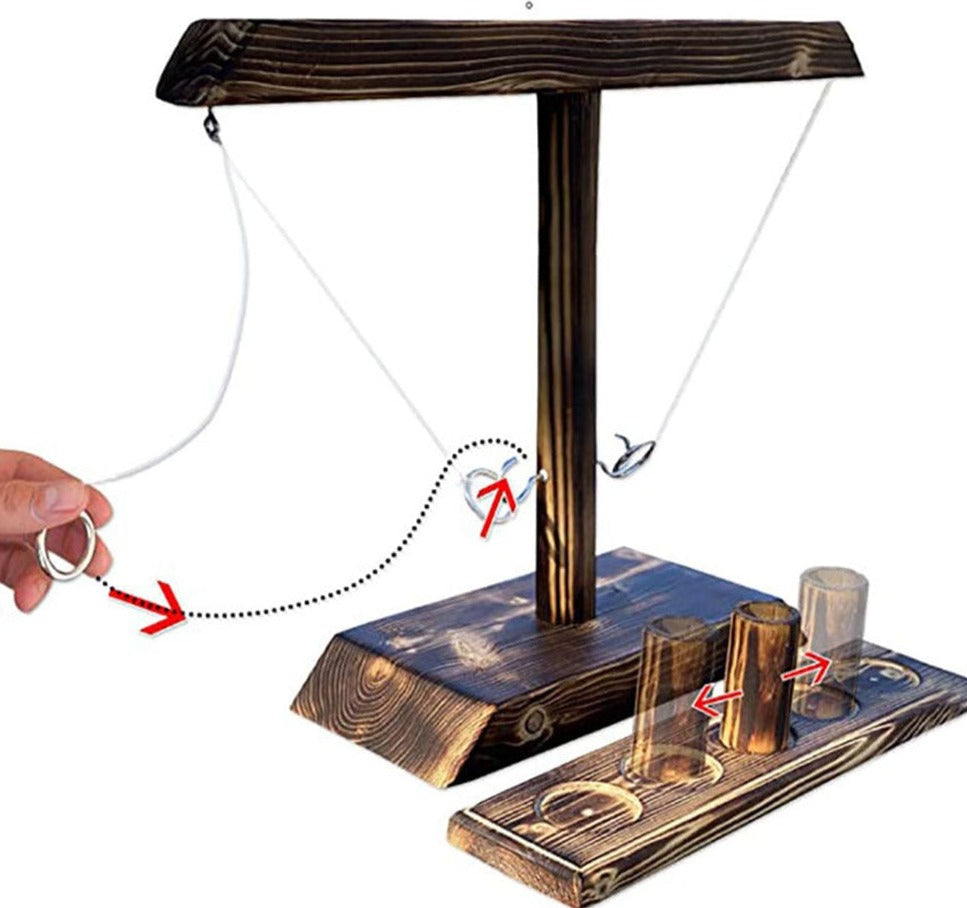 Ring toss game in action as player tosses ring toward wooden post.
