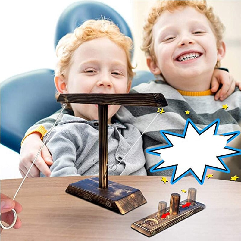 Kids laughing and enjoying wooden ring toss game together at party.