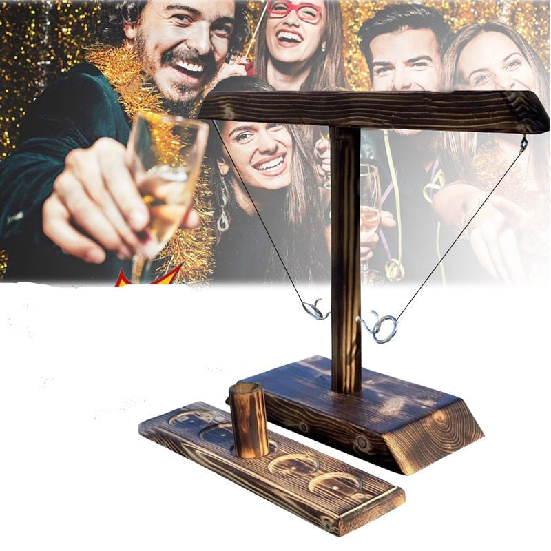 Wooden ring toss drinking game in festive party atmosphere setting.
