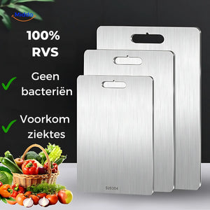 Three SafeCut stainless steel cutting boards in graduated sizes beside a basket of vegetables
