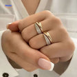 Adjustable ring with shimmering zirconia stones worn on hand.
