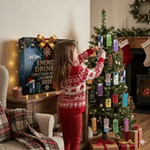 Energy drink advent calendar and mini cans displayed under a Christmas tree.