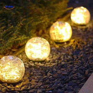 Solvion ambient garden lamp illuminating gravel pathway at dusk.