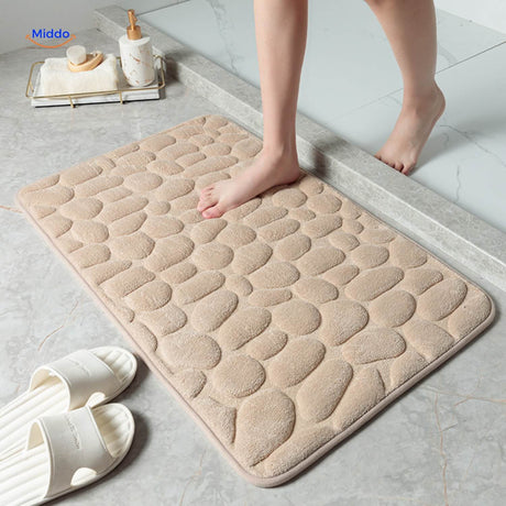 Anti-slip bath mat in beige tone offering comfort and water-absorbing benefits.