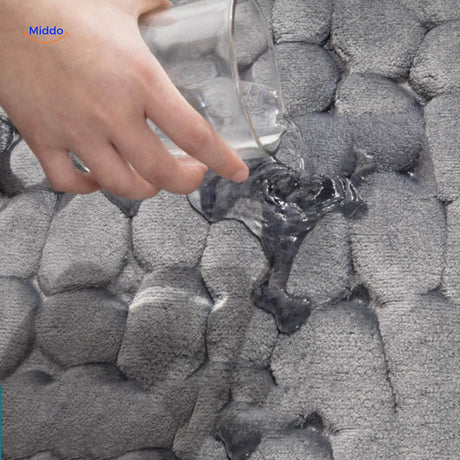 Close-up of anti-slip bath mat surface texture showing water-absorbing material.
