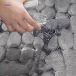 Close-up of anti-slip bath mat surface texture showing water-absorbing material.