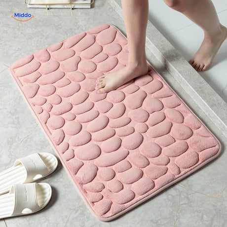 Anti-slip bath mat in pink color with water-absorbing and slip-resistant backing.