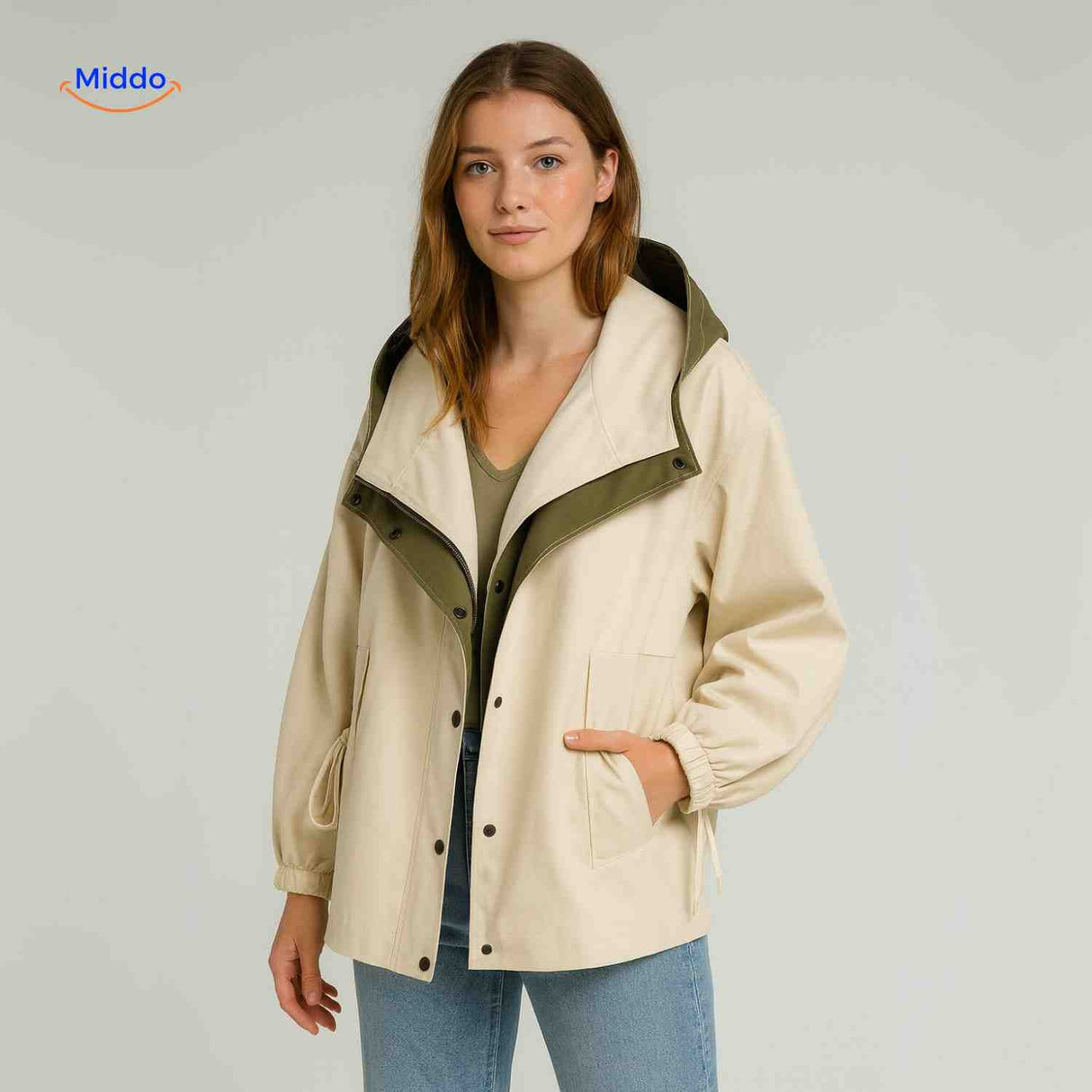 Lightweight AquaShell trench coat in cream with green lining and collar.